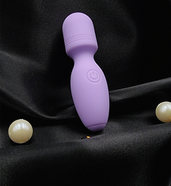 A close-up of The Luna Miniβs ultra-soft silicone body and easy-to-use power button for effortless pleasure control