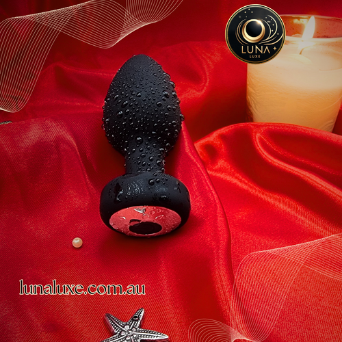 Black silicone anal plug with smartphone app control for personalized, discreet pleasure by Luna Luxe.