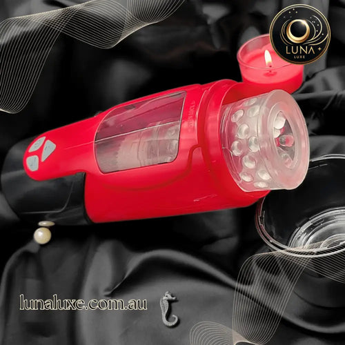 Lifestyle shot of the red Dark Knight telescopic masturbator on a black surface with clear sleeve.