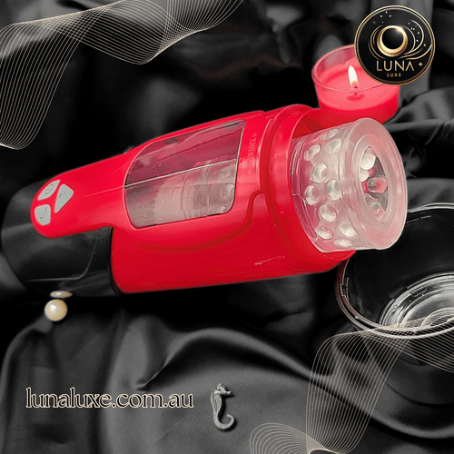 Lifestyle shot of the red Dark Knight telescopic masturbator on a black surface with clear sleeve.