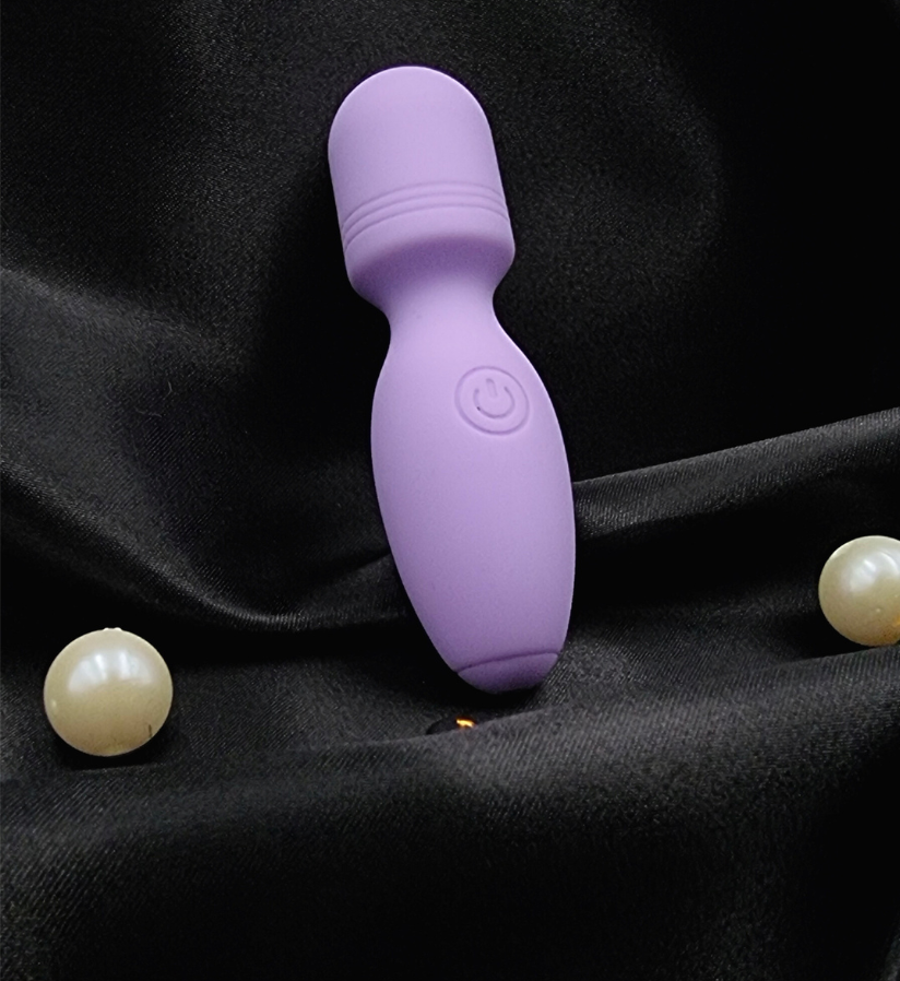 A close-up of The Luna Mini’s ultra-soft silicone body and easy-to-use power button for effortless pleasure control