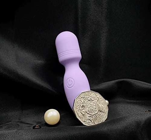 Product beside packaging: pocket-size rechargeable wand vibrator in purple.
