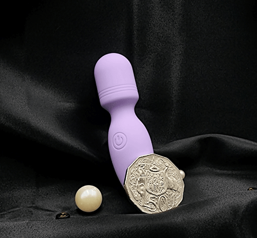 Product beside packaging: pocket-size rechargeable wand vibrator in purple.