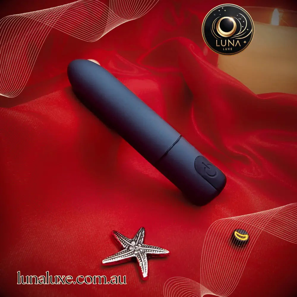 The Luna Bullet Buzz on red satin—compact 7-speed bullet for quick clitoral hits and discreet play.