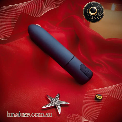 The Luna Bullet Buzz on red satin—compact 7-speed bullet for quick clitoral hits and discreet play.