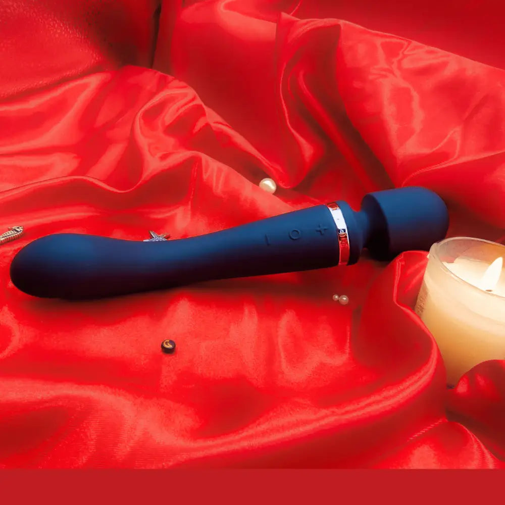 🌸 Curved purple wand angled on fabric, showing the sculpted G-spot arm for precise internal pressure.