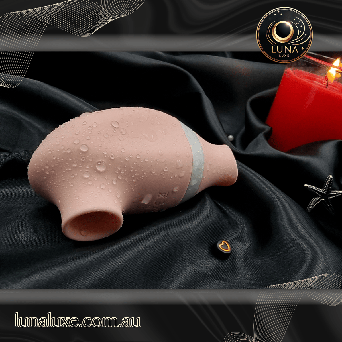 Clitoral suction toy on black satin—soft silicone mouth for deep, pulsing pleasure.