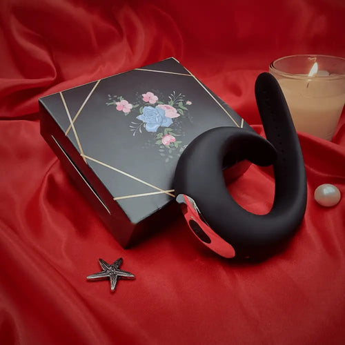 Close view of the adjustable strap cock ring beside a black card, showing buckle and texture.