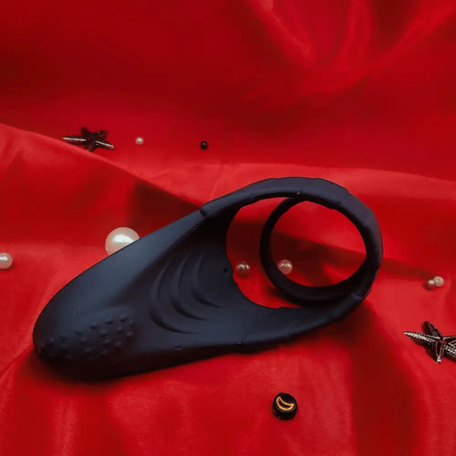 Side view of the cock ring with ball strap, showing detachable ring and flexible silicone body.