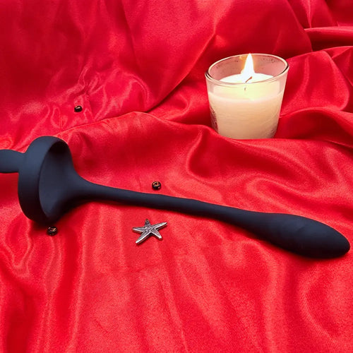 Side view of the silicone P-spot vibrator, showing ergonomic curve and textured base.