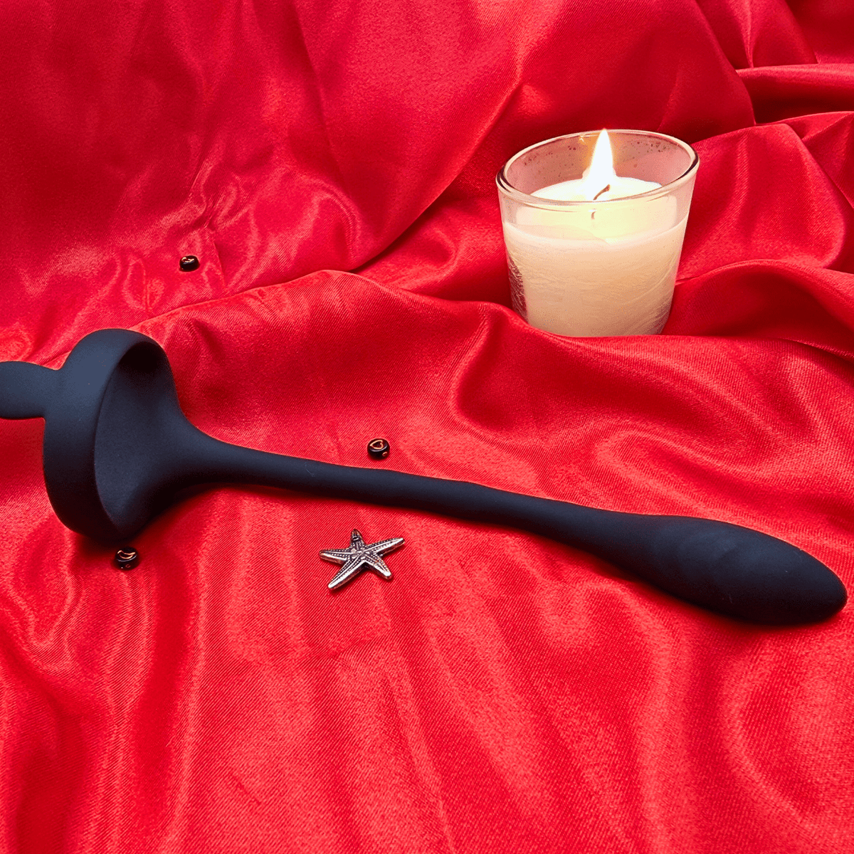 Side view of the silicone P-spot vibrator, showing ergonomic curve and textured base.