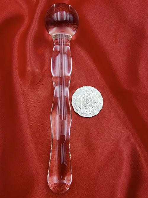Top-down shot of the beaded glass wand with rounded ends, highlighting solid borosilicate construction.