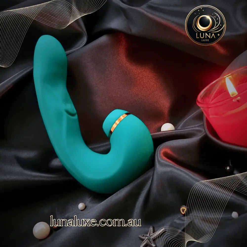 The Luna Pulse+ in teal on black silk, curved for deep G-spot pressure and clit suction in one.