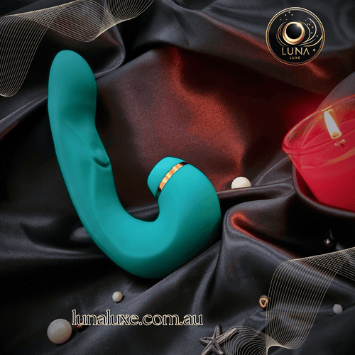 The Luna Pulse+ in teal on black silk, curved for deep G-spot pressure and clit suction in one.