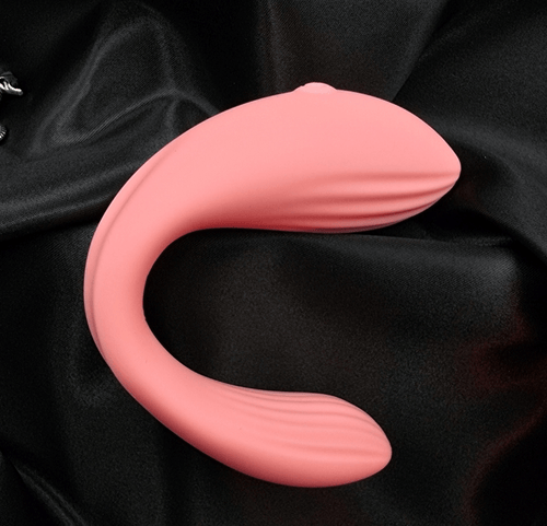 Side profile of the pink U-shape wearable vibrator, showing flexible neck and smooth exterior arm.