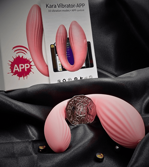 Two angles of the wearable vibrator on satin with packaging card, showing compact, discreet size.