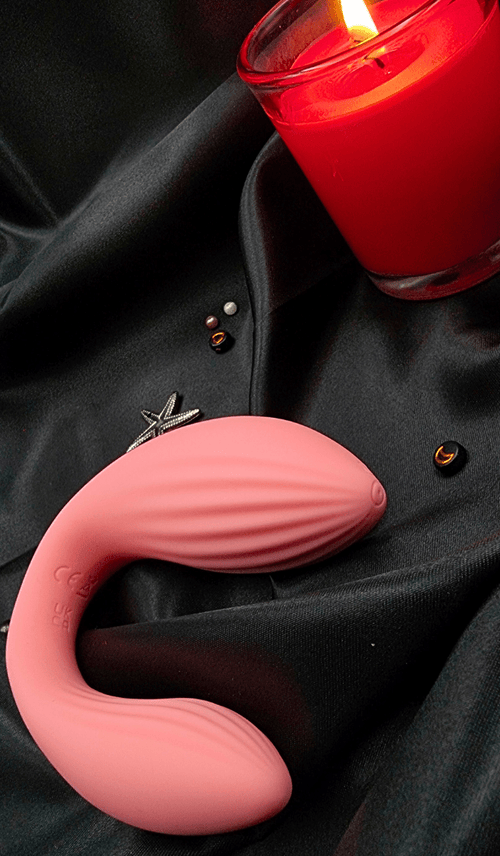 Top view near a candle highlighting the ridged internal arm and curved ergonomic design.